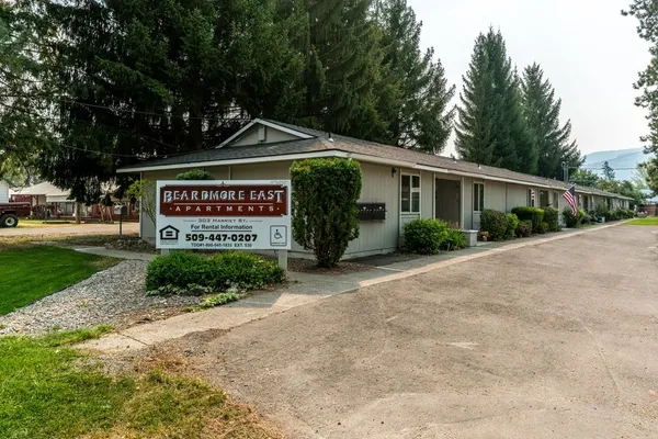 a view of sign board with yard and green space