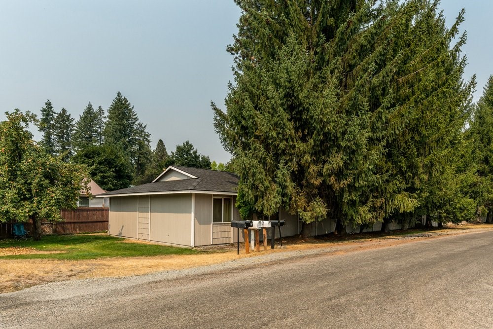303 Harriet Street Priest River, ID 83856 - Photo 9 of 9 a front view of a house with a yard and garage