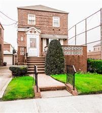136 Jaffray Street Brooklyn, NY 11235 - Photo 1 of 1 a front view of a house with a yard and a fence