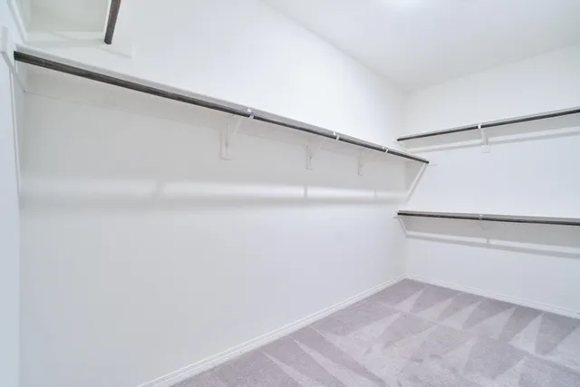 a bathroom with a toilet a sink a mirror and vanity