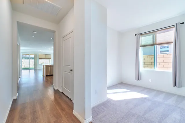 a view of walk in closet with empty racks