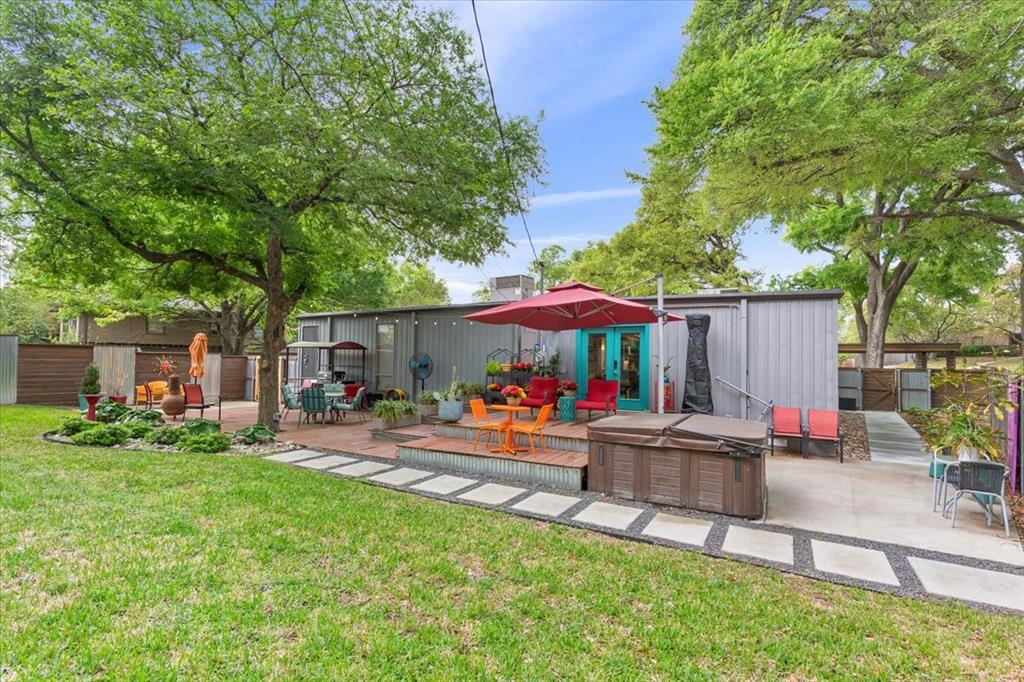 1617 Rambler Drive Waco, TX 76710 - Photo 35 of 36 Rear view of house with a patio area, a hot tub, a wooden deck, and a storage unit