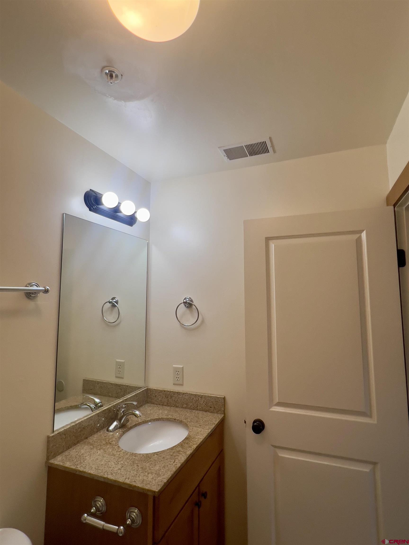540 Redcliff Circle, Unit E 203 Ridgway, CO 81432 - Photo 22 of 36 a bathroom with a sink and a mirror