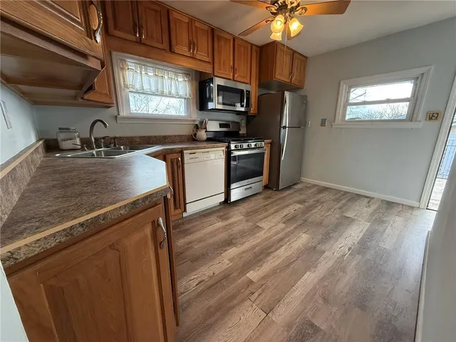 a kitchen with granite countertop a refrigerator stove and sink