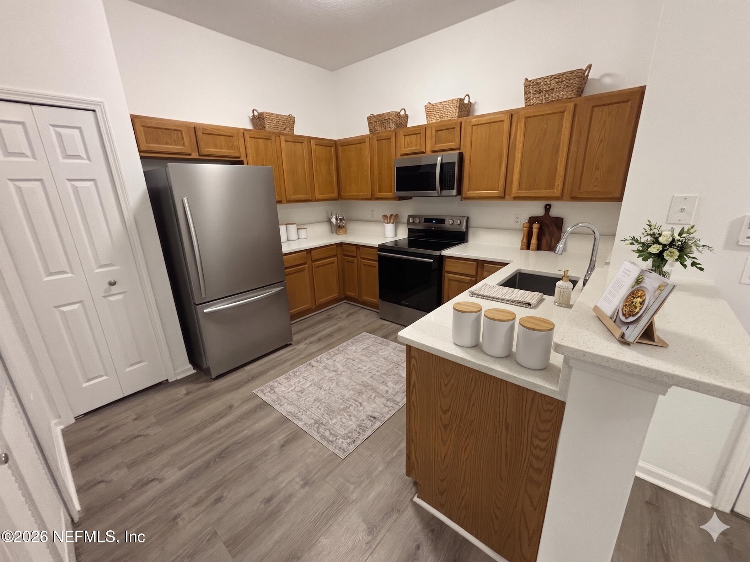 9627 Belda Way, Unit 8 Jacksonville, FL 32257 - Photo 1 of 27 a kitchen with a sink appliances and cabinets