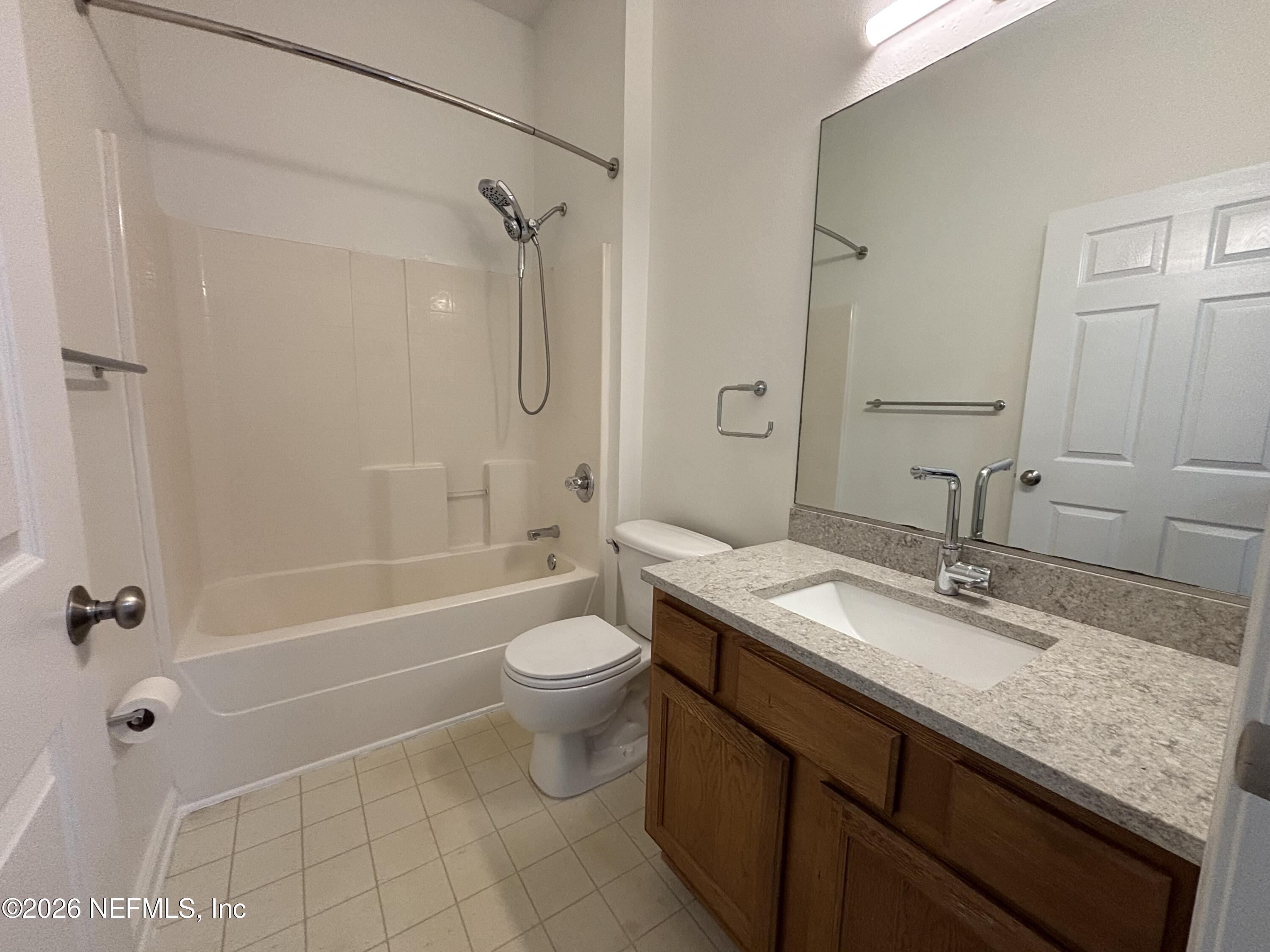 9627 Belda Way, Unit 8 Jacksonville, FL 32257 - Photo 11 of 27 a bathroom with a granite countertop sink toilet mirror and shower