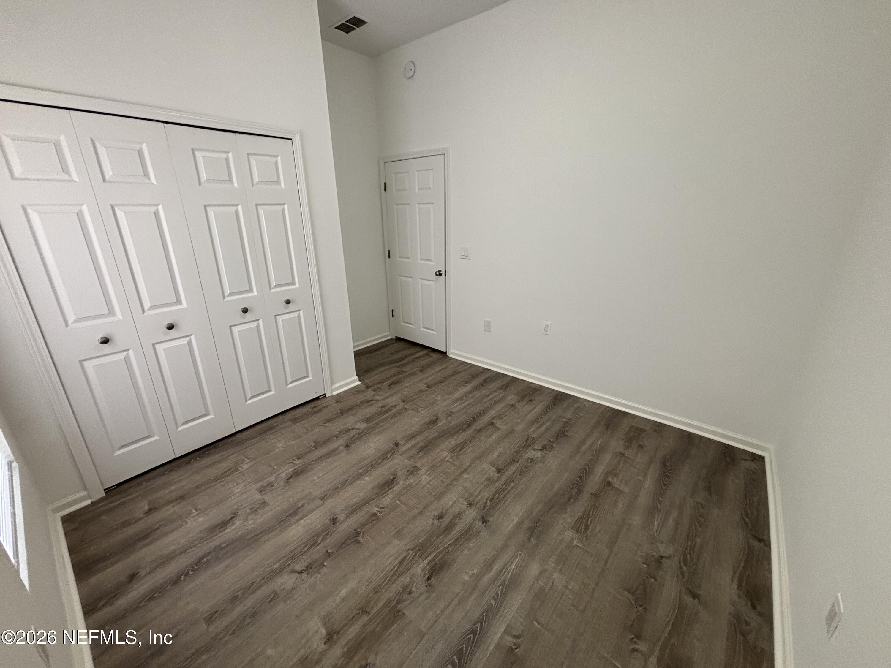 9627 Belda Way, Unit 8 Jacksonville, FL 32257 - Photo 16 of 27 a view of an empty room with wooden floor