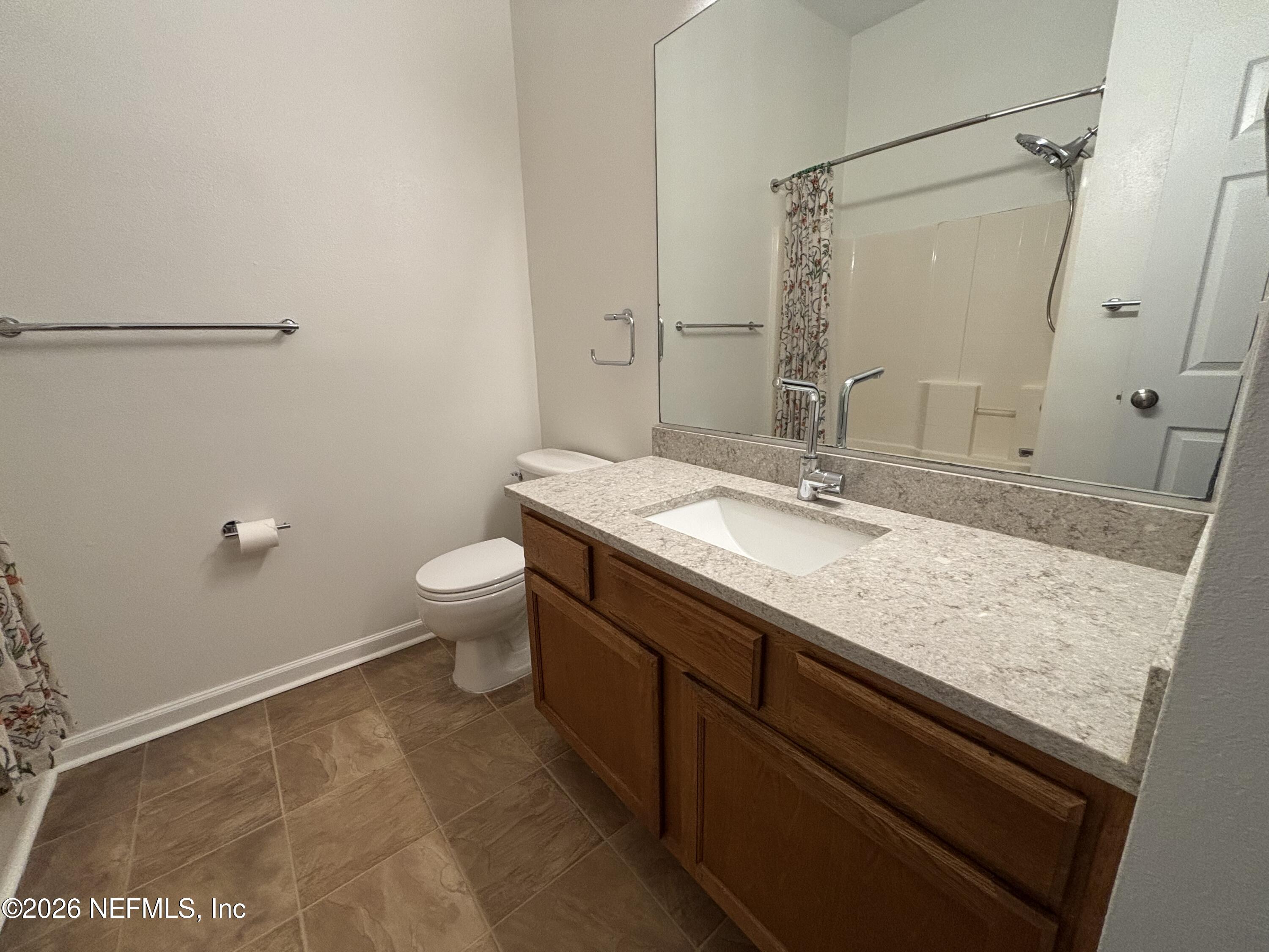 9627 Belda Way, Unit 8 Jacksonville, FL 32257 - Photo 18 of 27 a bathroom with a granite countertop sink a toilet a mirror and shower