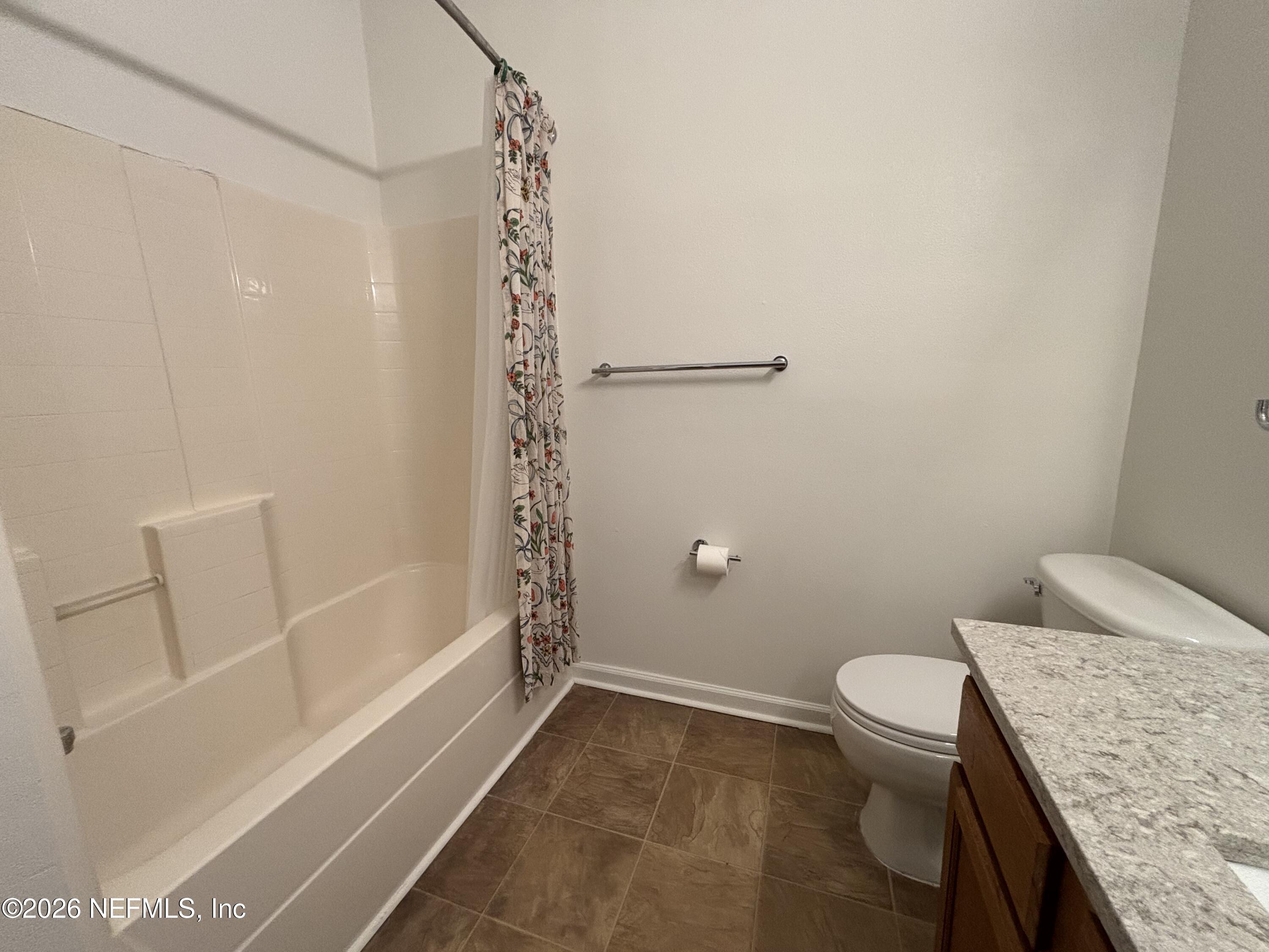 9627 Belda Way, Unit 8 Jacksonville, FL 32257 - Photo 19 of 27 a bathroom with a granite countertop sink toilet and shower