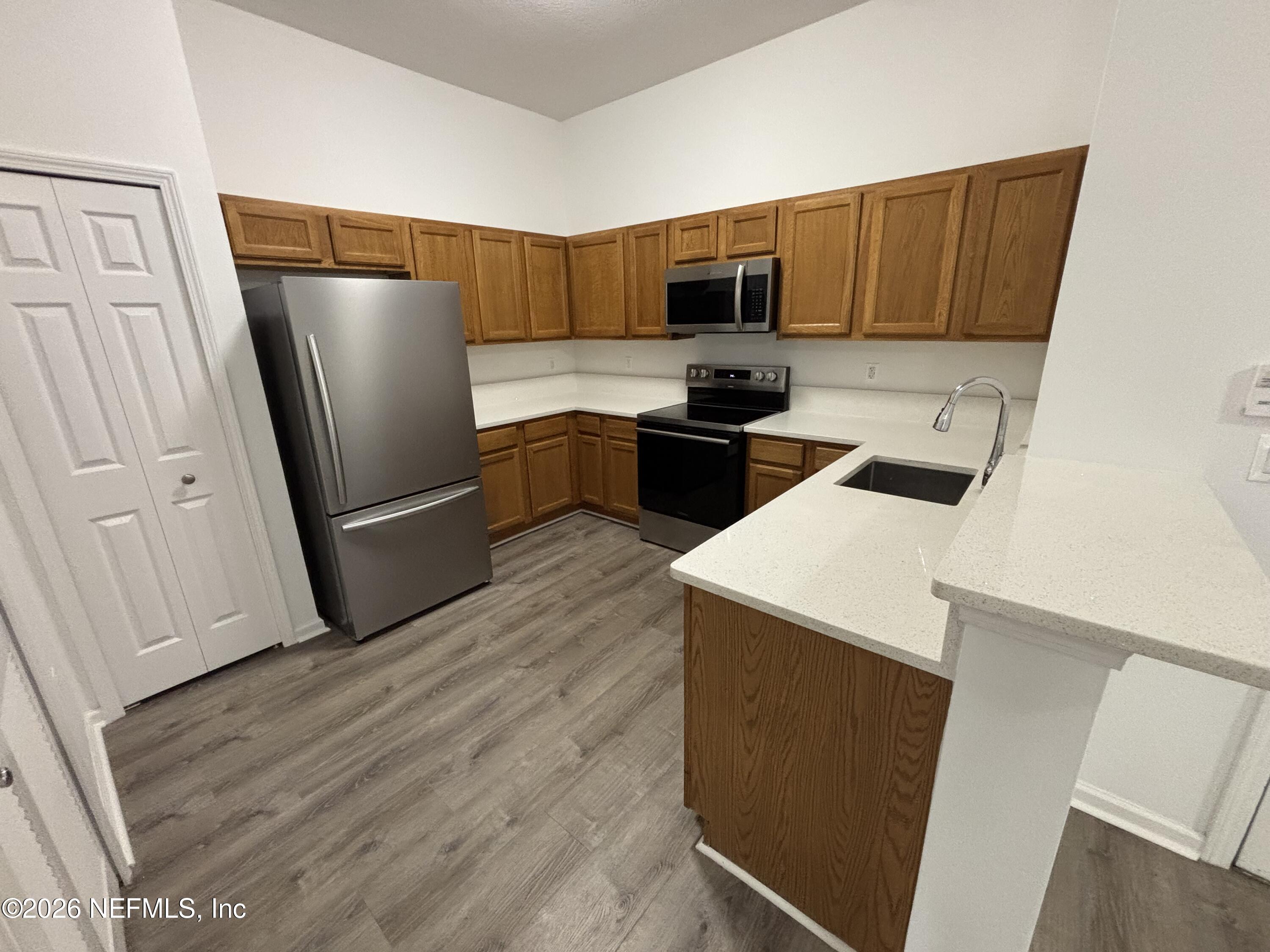 9627 Belda Way, Unit 8 Jacksonville, FL 32257 - Photo 2 of 27 a kitchen with a refrigerator sink and microwave