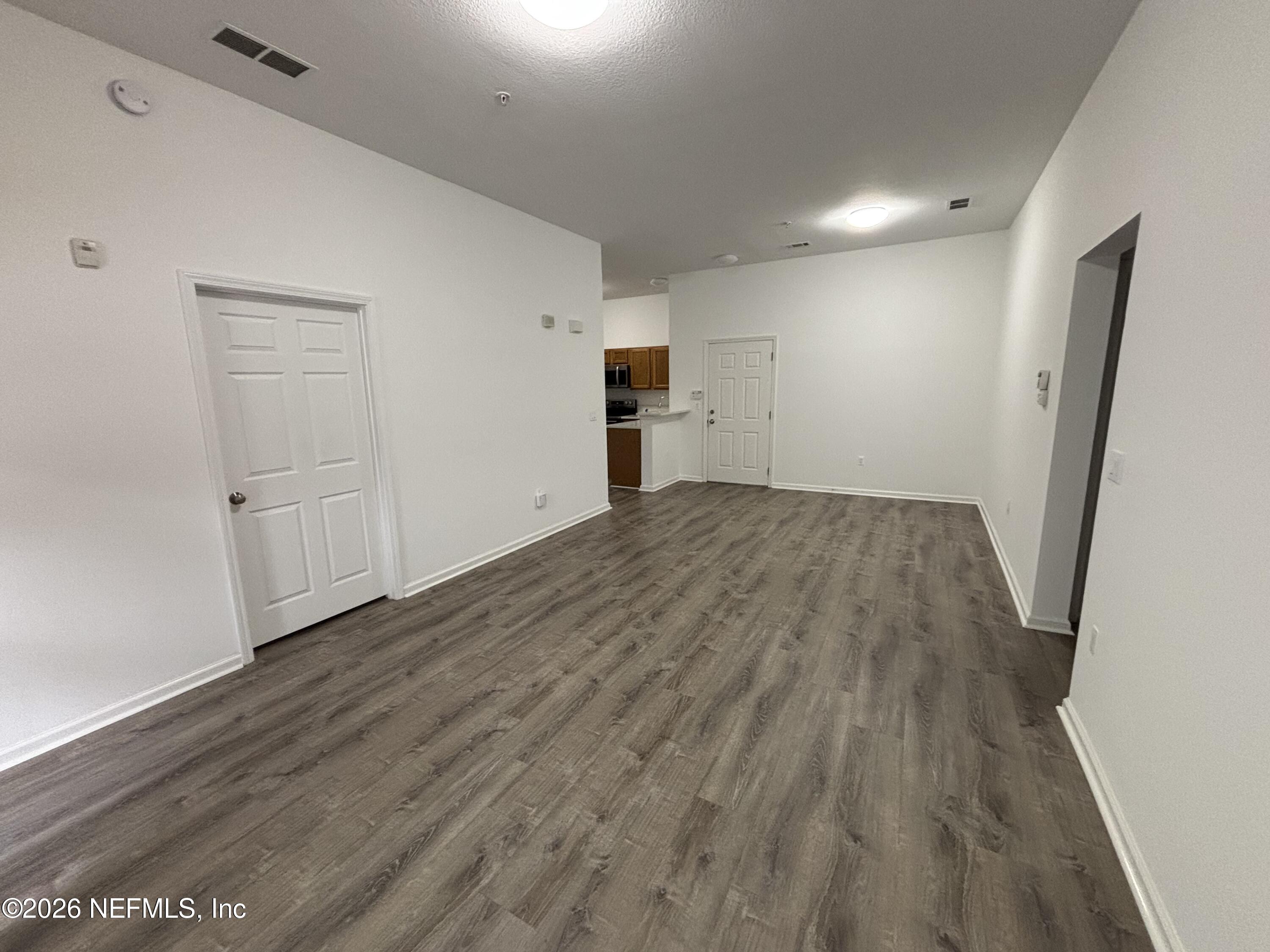 9627 Belda Way, Unit 8 Jacksonville, FL 32257 - Photo 5 of 27 wooden floor in an empty room with a window