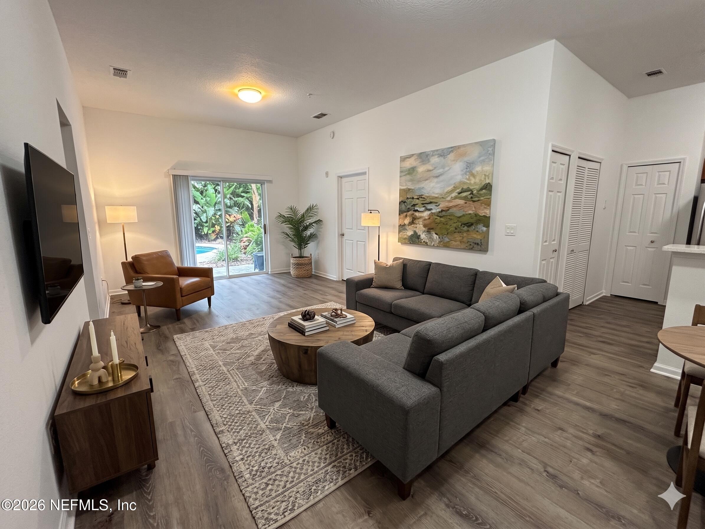9627 Belda Way, Unit 8 Jacksonville, FL 32257 - Photo 6 of 27 a living room with furniture and a flat screen tv