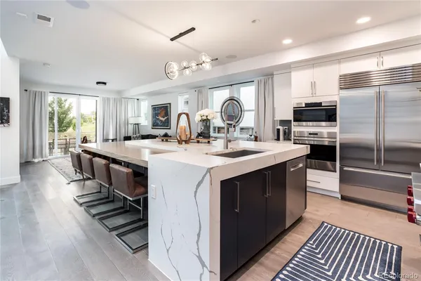 a kitchen with sink stove and refrigerator