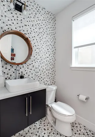 a bathroom with a sink toilet and mirror