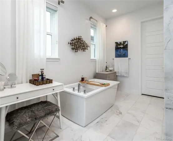 a bathroom with a tub sink and mirror
