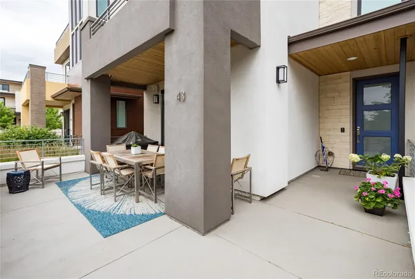 a view of a patio with table and chairs and potted plants