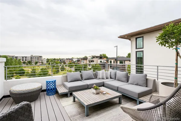an outdoor living room with patio a couch and city view
