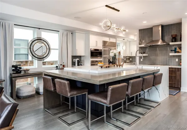 a kitchen with a stove a sink and a refrigerator