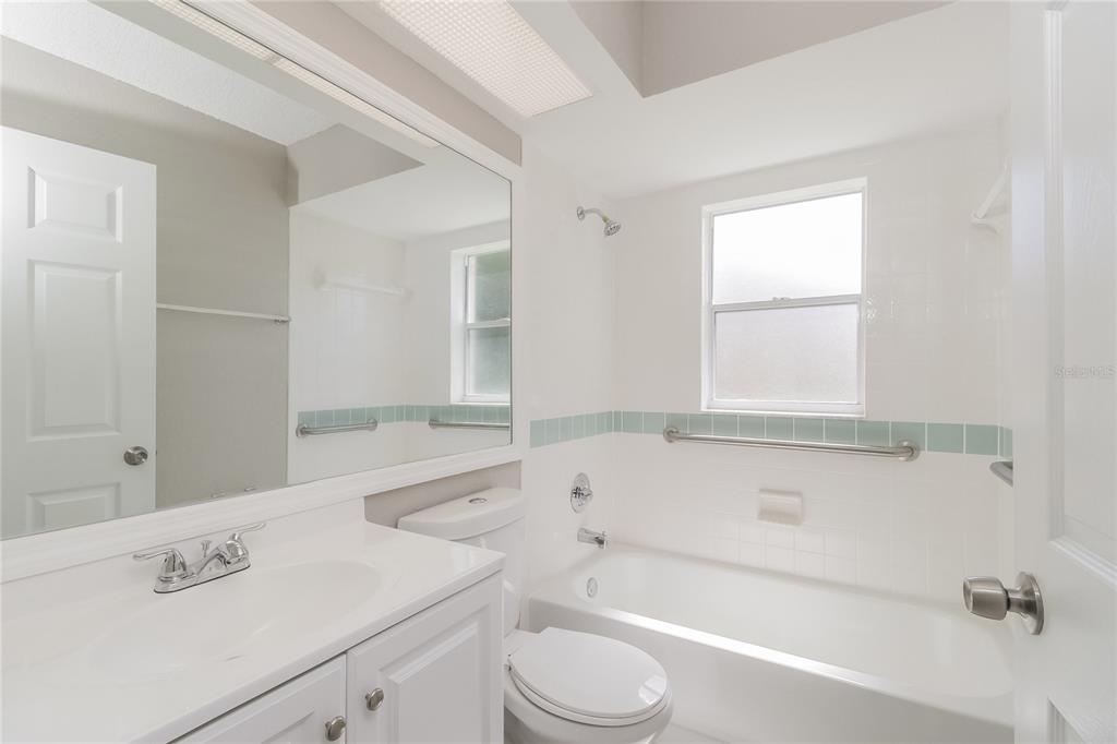 8358 Natoma Street Spring Hill, FL 34606 - Photo 13 of 16 a bathroom with a sink a toilet and bathtub