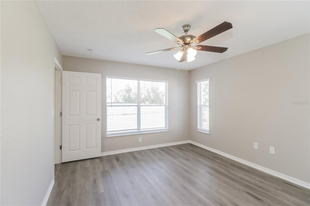 8358 Natoma Street Spring Hill, FL 34606 - Photo 9 of 16 a view of an empty room with window and wooden floor