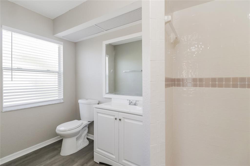 8358 Natoma Street Spring Hill, FL 34606 - Photo 10 of 16 a bathroom with a toilet a sink and a window