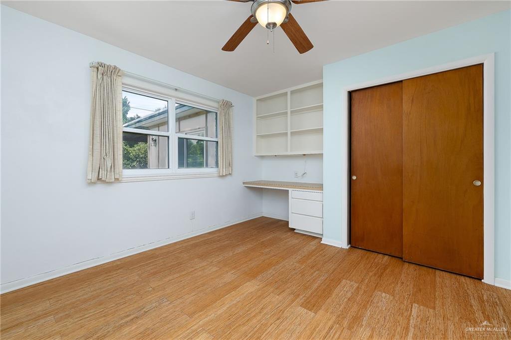 1001 West 7th Street Weslaco, TX 78596 - Photo 11 of 24 a view of empty room with wooden floor and fan