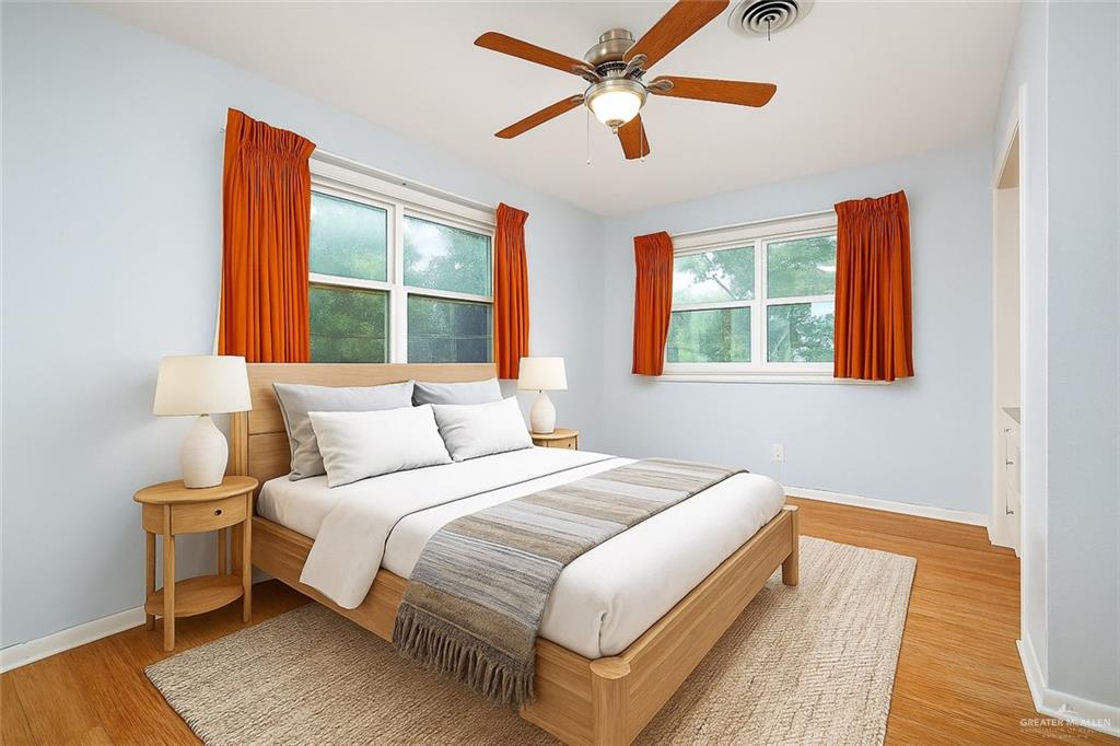 1001 West 7th Street Weslaco, TX 78596 - Photo 12 of 24 a bedroom with a large bed and a large window