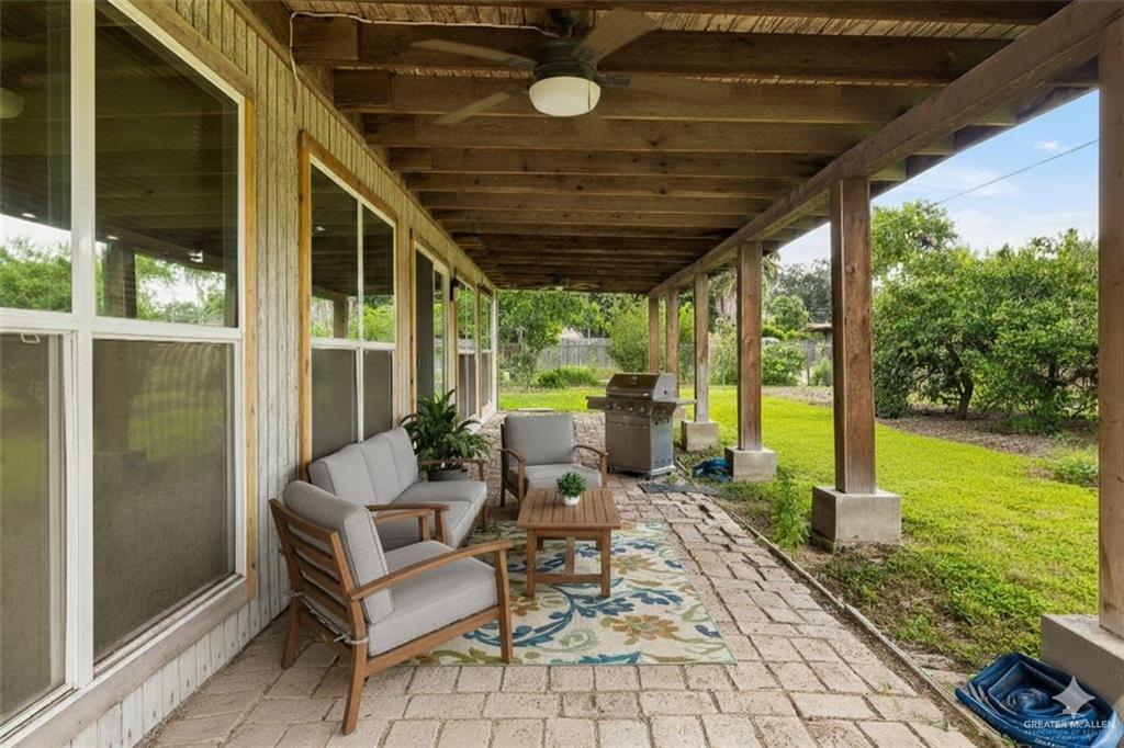 1001 West 7th Street Weslaco, TX 78596 - Photo 17 of 24 a patio view with a table and chairs and garden view