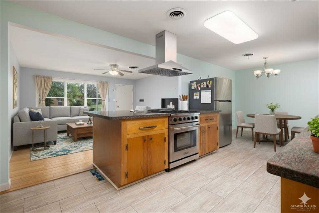 1001 West 7th Street Weslaco, TX 78596 - Photo 4 of 24 a kitchen with stainless steel appliances granite countertop a stove and a sink