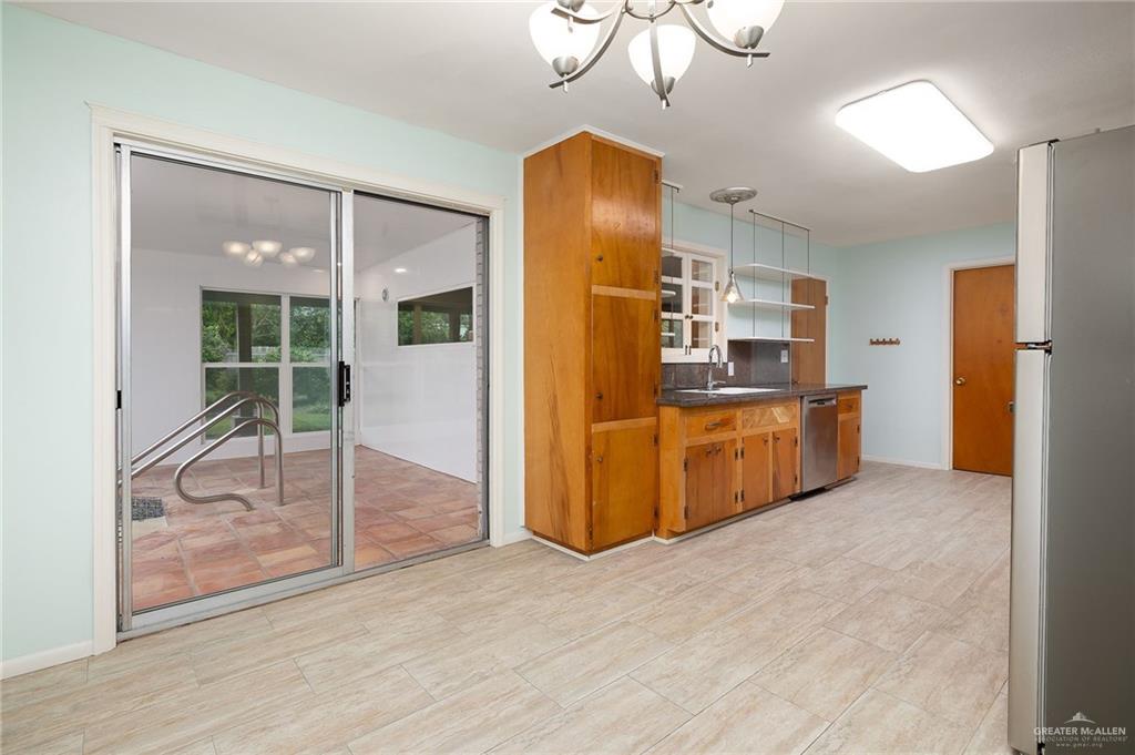 1001 West 7th Street Weslaco, TX 78596 - Photo 6 of 24 a kitchen with stainless steel appliances a refrigerator and a cabinets