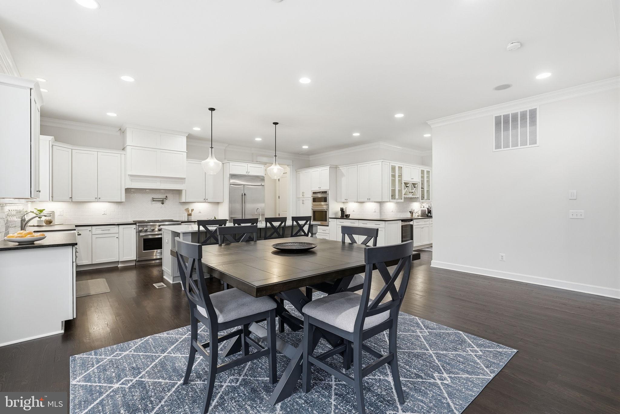 2867 Hill Road Vienna, VA 22181 - Photo 18 of 70 a kitchen with a dining table chairs and wooden floor