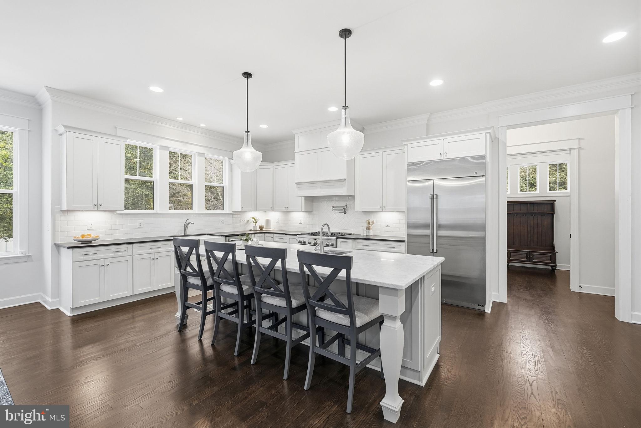 2867 Hill Road Vienna, VA 22181 - Photo 8 of 70 a kitchen with stainless steel appliances kitchen island granite countertop a dining table chairs and white cabinets