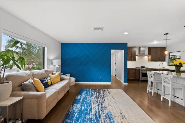 a view of a patio with dining table and chairs with wooden floor and fence