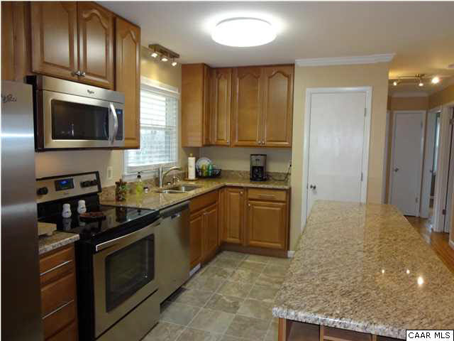 233 Hartmans Mill Road Charlottesville, VA 22902 - Photo 6 of 13 a kitchen with stainless steel appliances granite countertop a stove a sink and a microwave