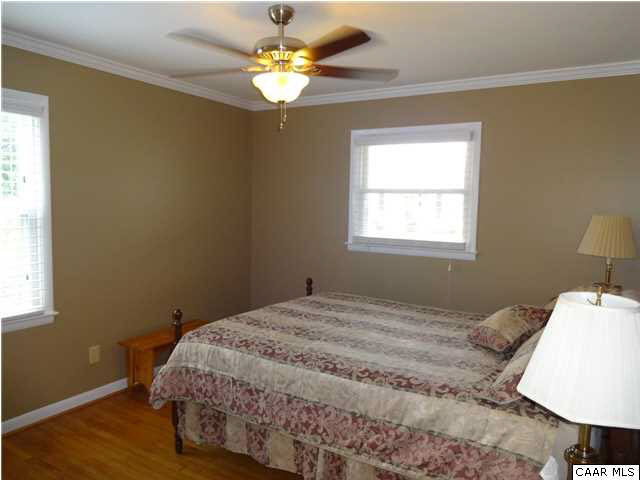 233 Hartmans Mill Road Charlottesville, VA 22902 - Photo 7 of 13 a bedroom with a bed chandelier and a window