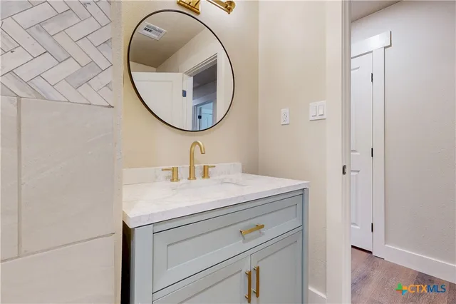 a bathroom with a sink and a mirror