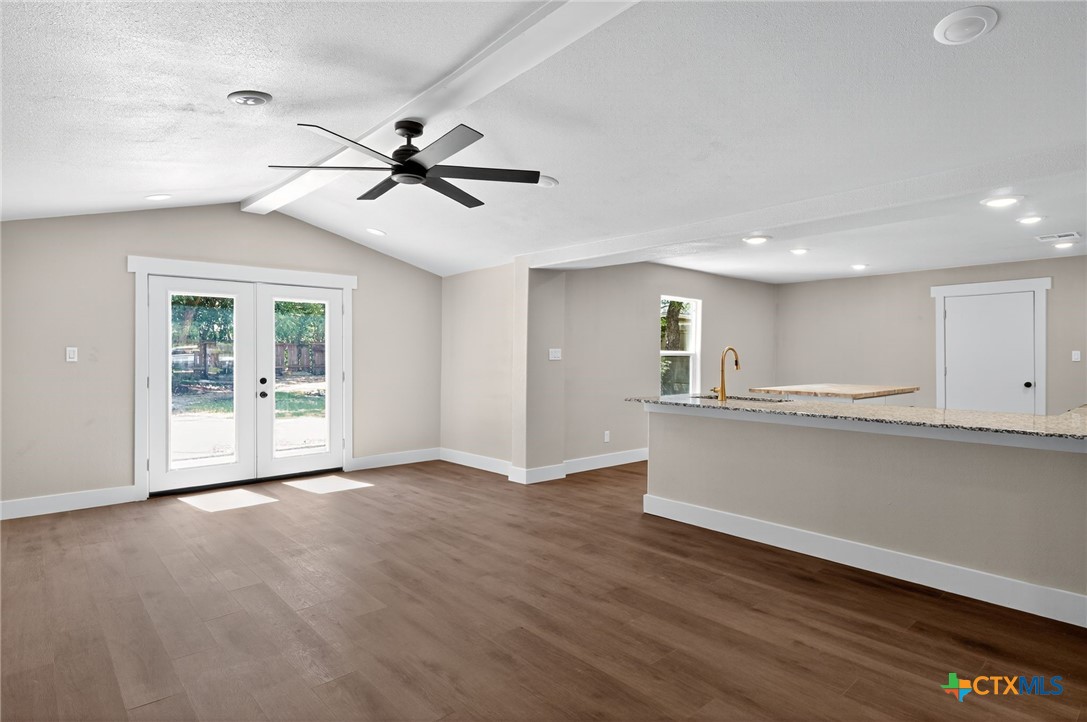 601 West Zenith Avenue Temple, TX 76501 - Photo 7 of 25 a view of empty room with wooden floor and fan