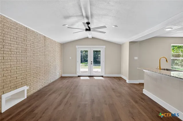 a view of workspace with wooden floor and a window