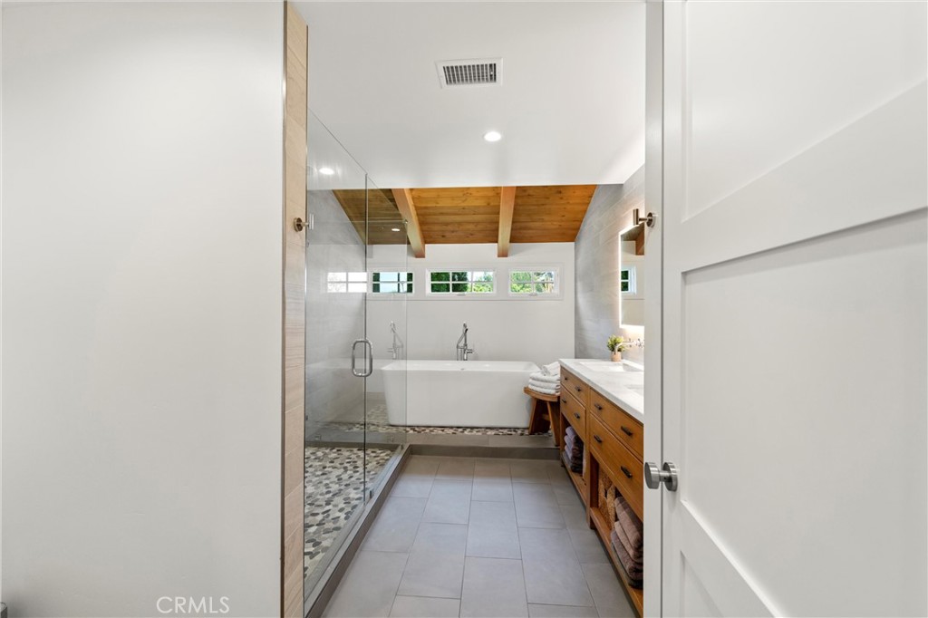 7337 La Soldadera Rancho Santa Fe, CA 92067 - Photo 33 of 60 a bathroom with a double vanity sink and a bathtub