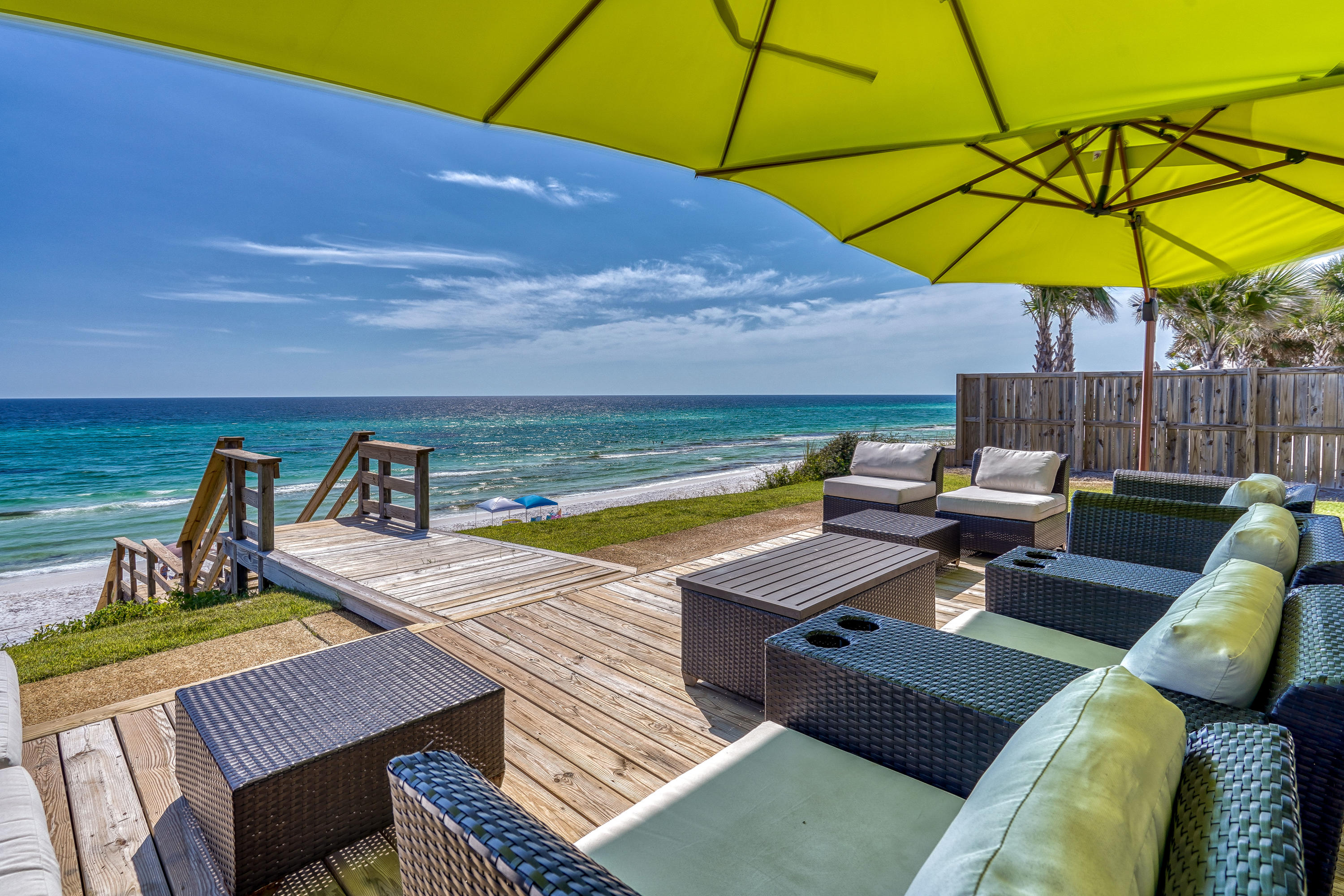 a view of a patio with chairs under an umbrella