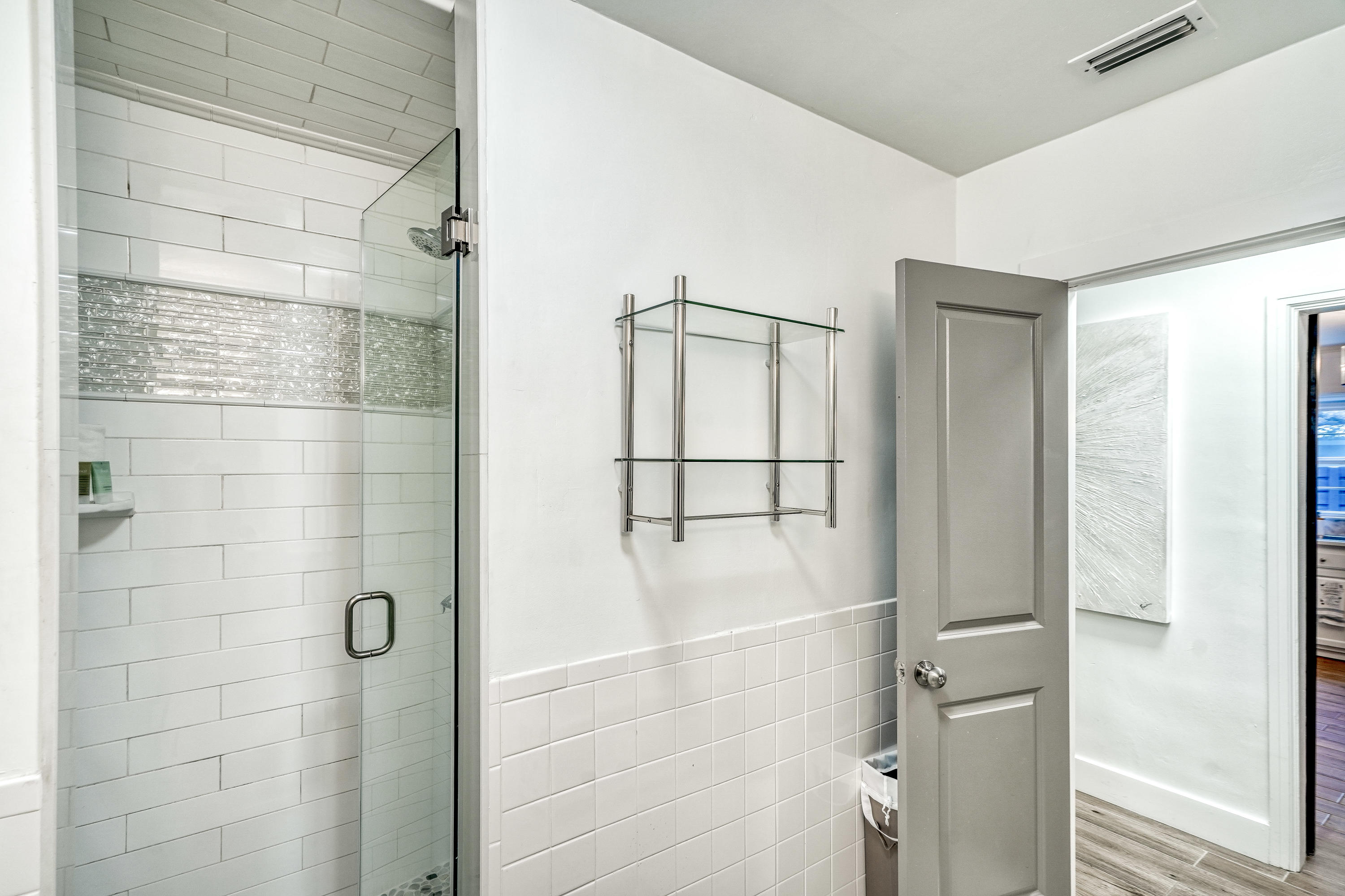 2912 East County Highway 30A Santa Rosa Beach, FL 32459 - Photo 17 of 43 a bathroom with a glass shower door