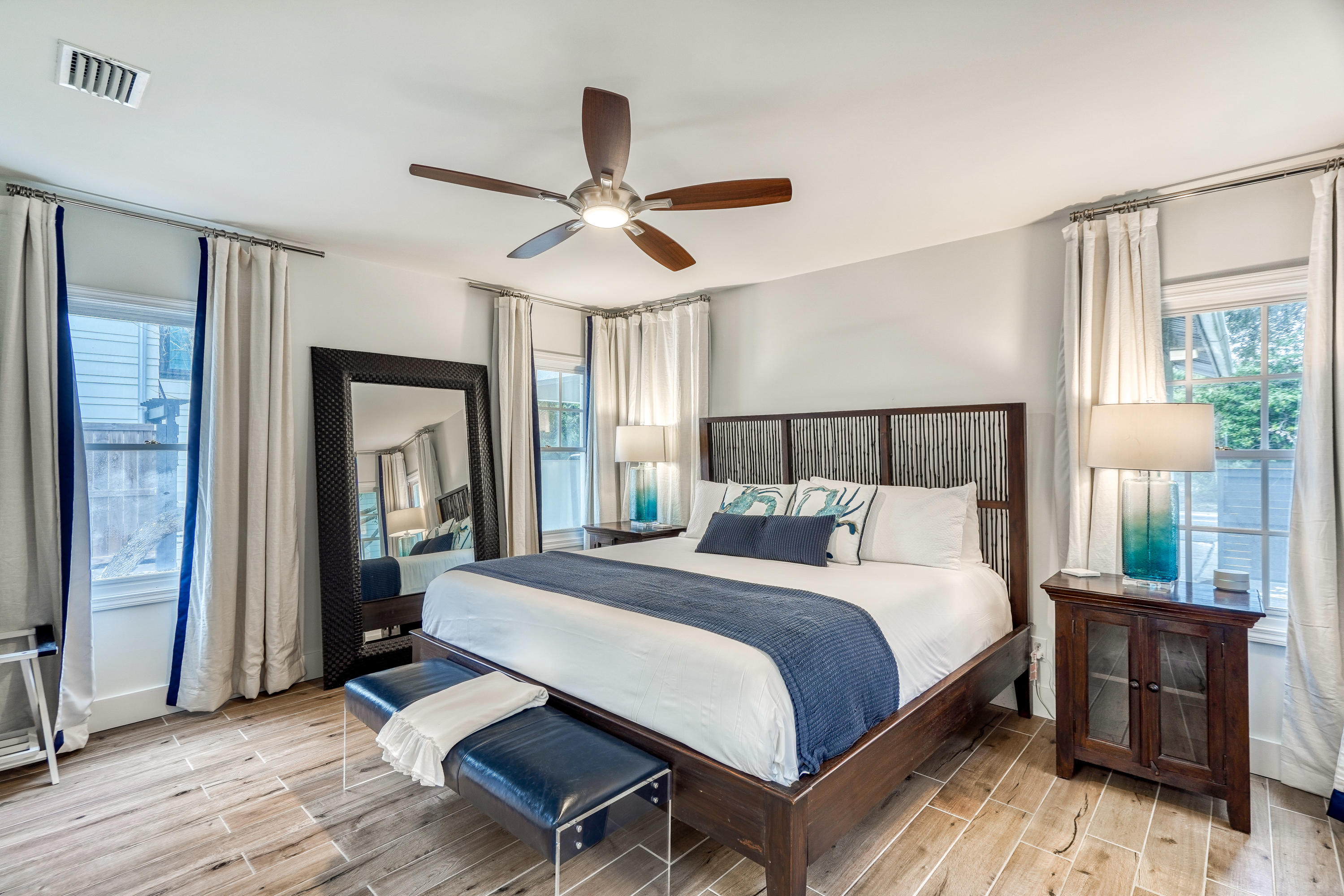 2912 East County Highway 30A Santa Rosa Beach, FL 32459 - Photo 18 of 43 a bedroom with a large bed and a chandelier