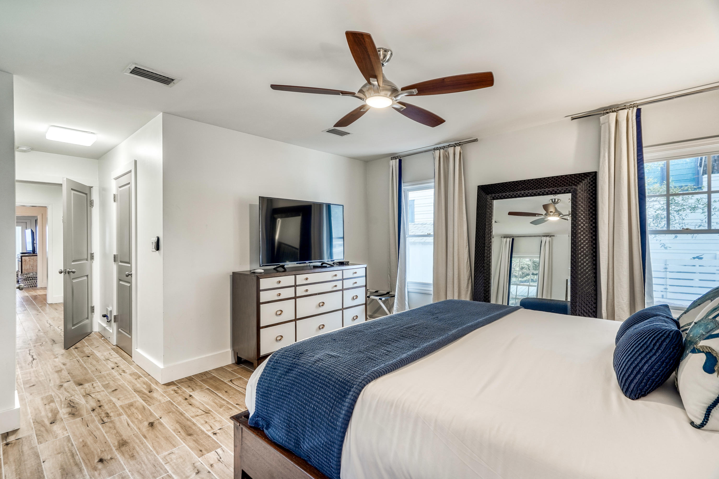 2912 East County Highway 30A Santa Rosa Beach, FL 32459 - Photo 19 of 43 a bedroom with a large bed and a flat tv screen