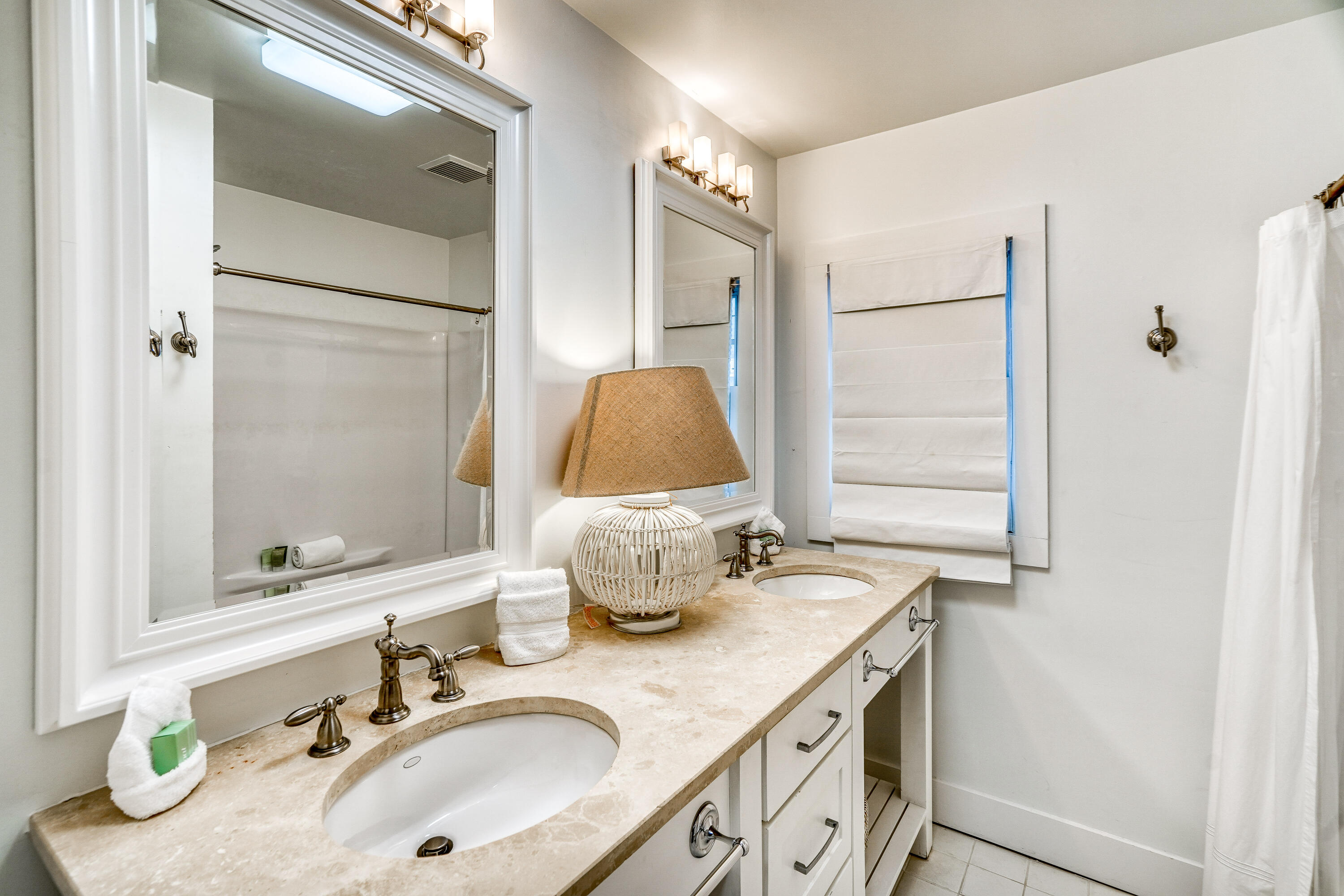 2912 East County Highway 30A Santa Rosa Beach, FL 32459 - Photo 21 of 43 a bathroom with a granite countertop sink and a mirror