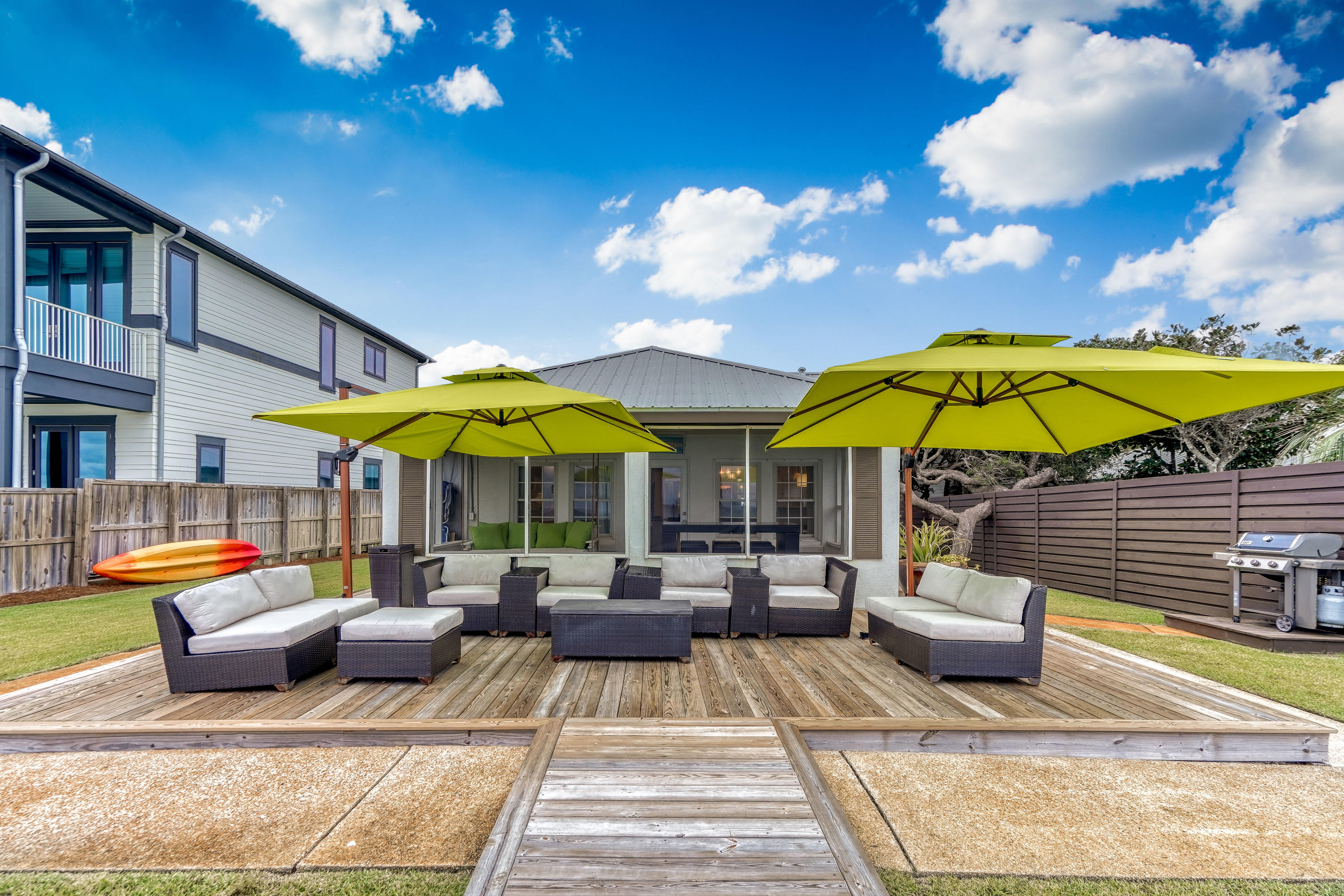 2912 East County Highway 30A Santa Rosa Beach, FL 32459 - Photo 32 of 43 a view of a patio with a table and chairs under an umbrella