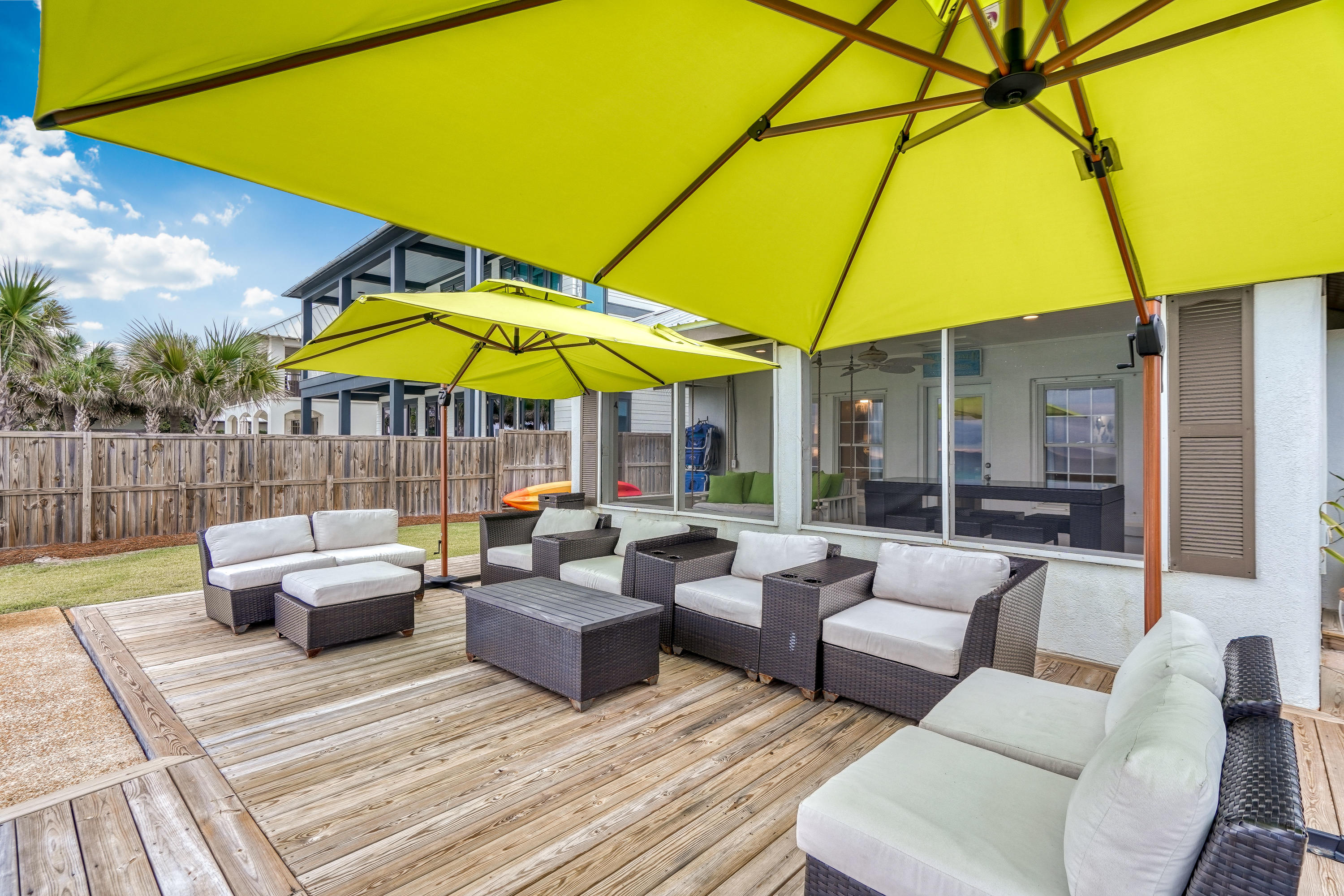 2912 East County Highway 30A Santa Rosa Beach, FL 32459 - Photo 33 of 43 a view of a patio with couches and table under an umbrella