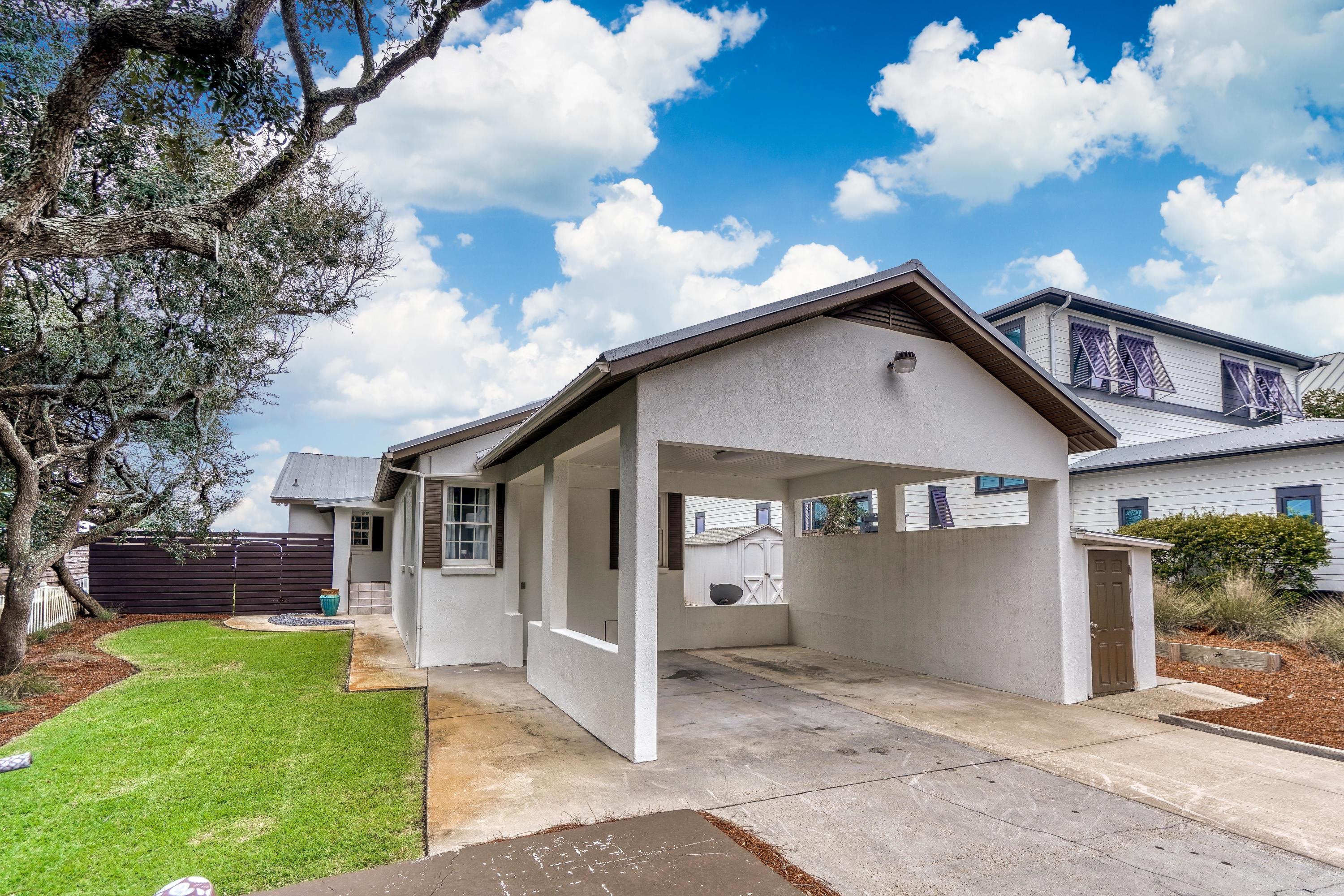 2912 East County Highway 30A Santa Rosa Beach, FL 32459 - Photo 35 of 43 a view of a white house with a yard and plants