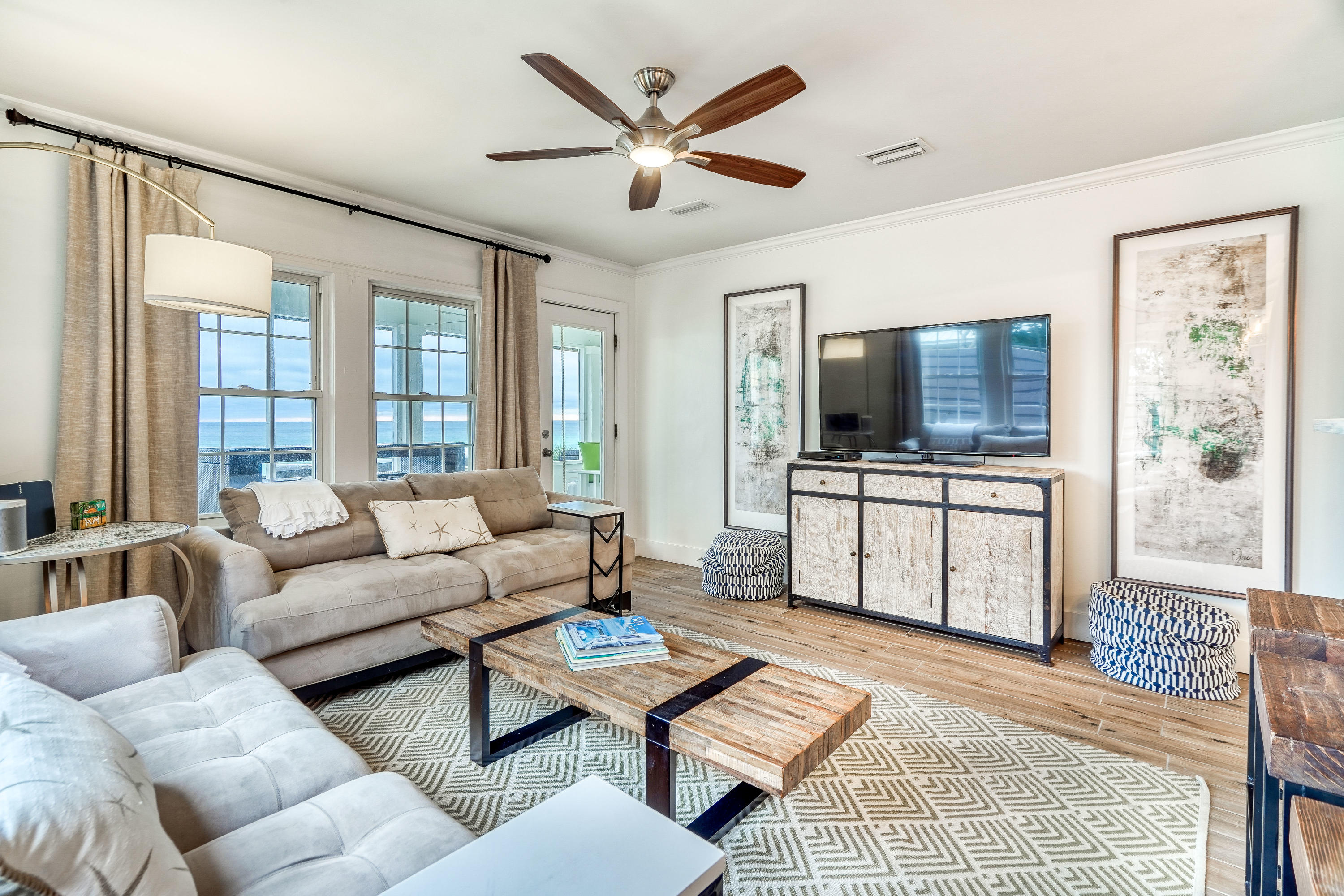 2912 East County Highway 30A Santa Rosa Beach, FL 32459 - Photo 4 of 43 a living room with furniture a flat screen tv and a large window