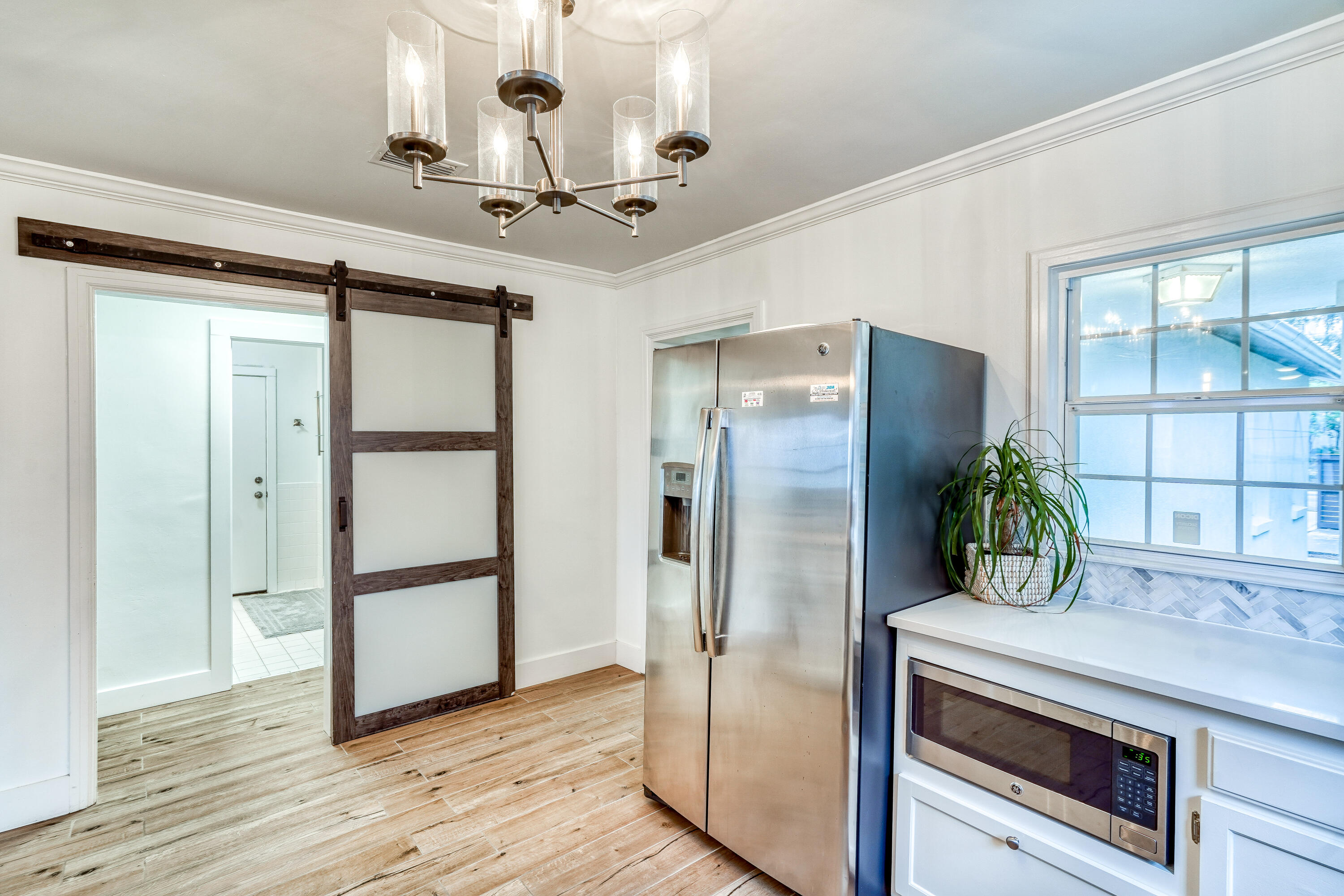 2912 East County Highway 30A Santa Rosa Beach, FL 32459 - Photo 8 of 43 a kitchen with stainless steel appliances a refrigerator and wooden floor