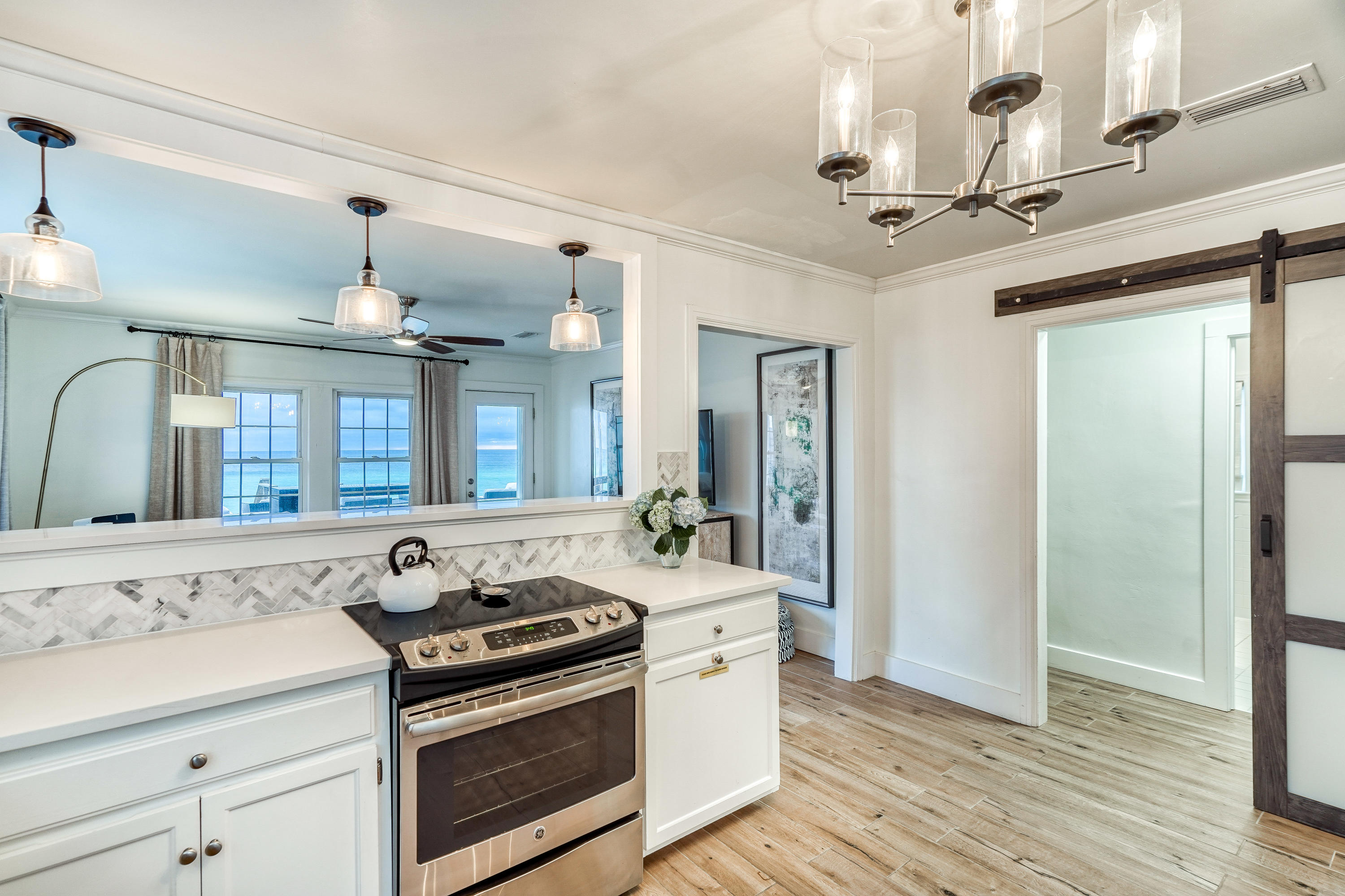 2912 East County Highway 30A Santa Rosa Beach, FL 32459 - Photo 9 of 43 a view of a bathroom with a sink a mirror and a shower
